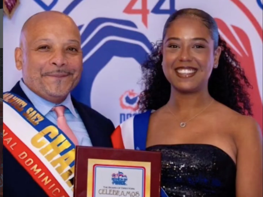 Honoree with Manny Saez, Chairman of the National Dominican Day Parade, holding an award at the Benefit Gala